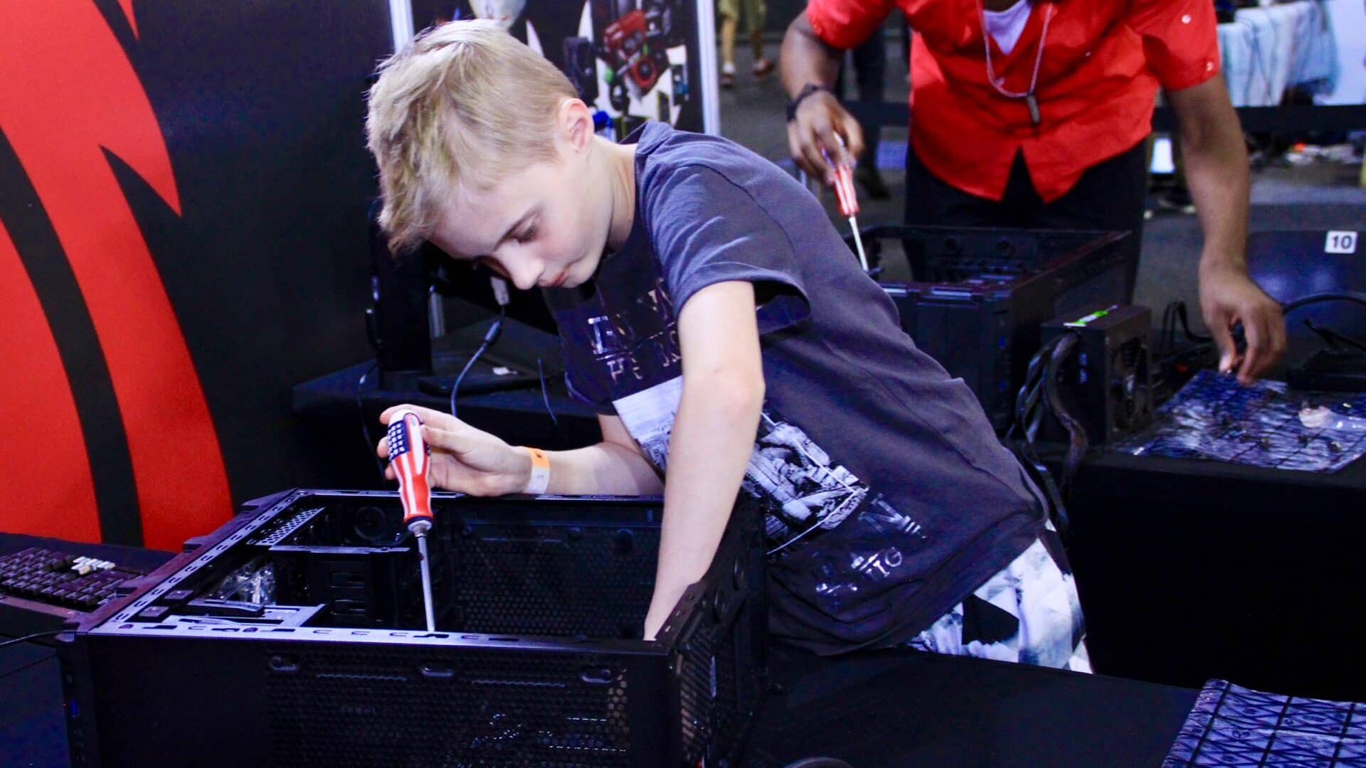 Kid building a PC at the MSI Gaming PC Workshop brand activation