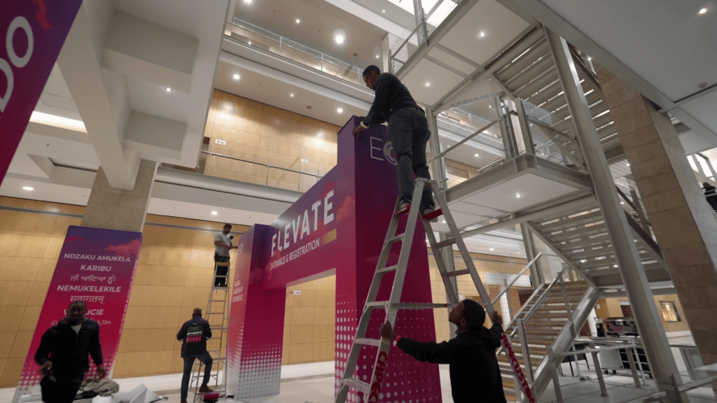 Workers installing custom printed doorways at an event