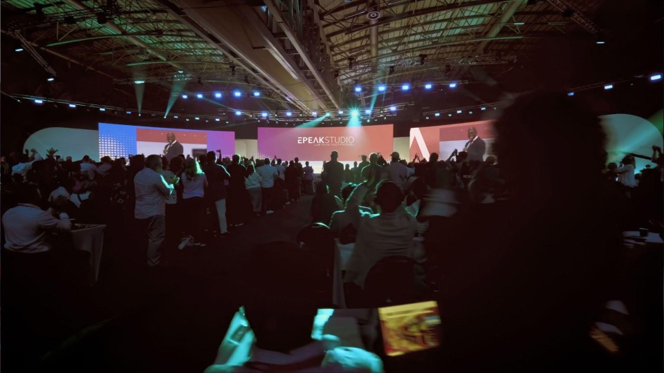 A picture of an event where EPEAK Studio is celebrated, with their logo on the main screen